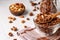 Granola crispy muesli with natural honey, chocolate and nuts in a glass bowl against a white background, healthy food, horizontal