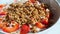 Granola falling in yogurt with strawberries, Slow Motion.