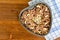 Granola in a heart-shaped baking sheet on a wooden table. Food Concept