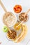 Granola ingredients on white wood background