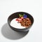 Granola or Muesli in Black Restaurant Bowl Isolated