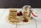 Granola with nuts in a glass jar, strawberry, a pile of oatmeal