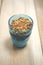 Granola Parfait in Blue Tumbler on Wooden Surface