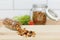 Granola scattered from a glass bottle on a wooden table