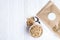 Granola superfood with almond and cashew nuts, dry fruits, raisins cherry in the ceramic jar on the white wooden table, top view,