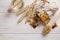 Granola superfood with almond and cashew nuts, dry fruits, raisins cherry in the ceramic jar on the white wooden table, top view,