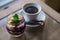 Granola with yogurt and blackberry jam with mint leaf on top and cup of coffee. Blurred background. Healty breakfast. Fitness food
