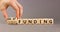 Grant funding symbol. Concept words Grant funding on beautiful wooden blocks. Beautiful grey table grey background. Businessman