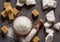 Granulated table sugar in wooden bowl and in the spoon and sugar cubes around it on the table