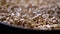 Granules of Pressed Wood Sawdust Fall in Pile of Pellets on Rotating Background