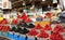 Granville Island woman in a mask sells raspberries, strawberries and ojin, everything is on the counter in containers