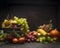 Grape, apples and autumn fruits and vegetables in an iron bowl with a sunflower on a wooden table on a dark wall background