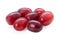Grape bunch isolated on white background. Sweet ripe fresh pink fruit. Heap of red cardinal grapes. Clipping path