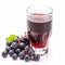 Grape juice. Glass of fresh appetizing black grape juice and a bunch of berries isolated on white