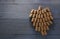 Grape made of wine bottle corks on grey wooden table, top view. Space for text