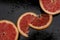 Grapefruit close up on black stone background