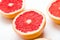 Grapefruit cut in halves on a white background. Useful tropical citrus diet fruit