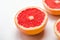 Grapefruit cut in halves on a white background. Useful tropical citrus diet fruit