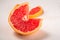 Grapefruit cut in macro, tropical creative minimal food fruit concept, on white background