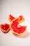 Grapefruit cut in macro, tropical creative minimal food fruit concept, on white background