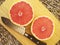 A grapefruit cutted in half with a knife