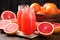 grapefruit halves, full fruit, and juice in a mason jar