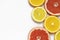 Grapefruit and lemon slices on white background. Tropical bright juicy fruit vegetarian healthy diet flat lay banner