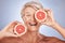 Grapefruit, portrait of happy senior woman in studio or natural skincare product for vegetarian lifestyle. Detox diet