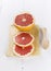 Grapefruit segments on a white wooden background