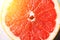 Grapefruit sliced half on grey background. Citrus fruit macro. Copy space, top view. Summer food concept