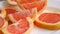 Grapefruit Slices On A White Plate