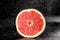 Grapefruit with water drops on black background. Citrus fruit. Healthy freshness food. fruit with vitamin