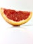 Grapefruit wedge on a white surface