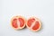 Grapefruit on a white background. A grapefruit cut in half. Citrus fruit.