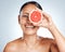 Grapefruit, woman and vitamin c beauty, portrait and skincare wellness on studio background. Happy model, face and