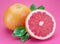 Grapefruits and grapefruit slices isolated on pink background