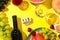 Grapes, a bottle of wine and different fruits on a yellow background. English text August 15, traditional Italian