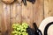 Grapes, bottle of wine, glass with wine, hat on a wooden background. Winemaking and harvesting concept in Europe, italy