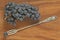 Grapes. A bunch of dark, black grapes lies on a wooden board close-up and a vintage fork