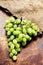 Grapes harvest. White grapes bunch over wooden background. G