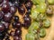 Grapes kishmish on a wooden background. The grapes are overripe. Harvest in the village