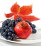 Grapes, pomegranate and autumn leaf closeup