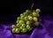Grapes on purple table cloth