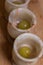 Grapes in small stone glasses on a wooden surface