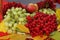 Grapes, viburnum, apples in a wicker basket close-up. seasonal fruits