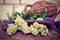 Grapes and vintage wicker bottle on the wooden table