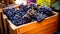 Grapes in a wooden box on the counter of a winery