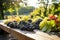 Grapes on a wooden table against the backdrop of a vineyard in summer. Grape harvest