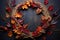 a grapevine wreath beside assorted autumn leaves