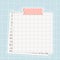Graph square mockup paper with dots, piece of newspaper is on the bottom, pink washi tape with lines is on the top